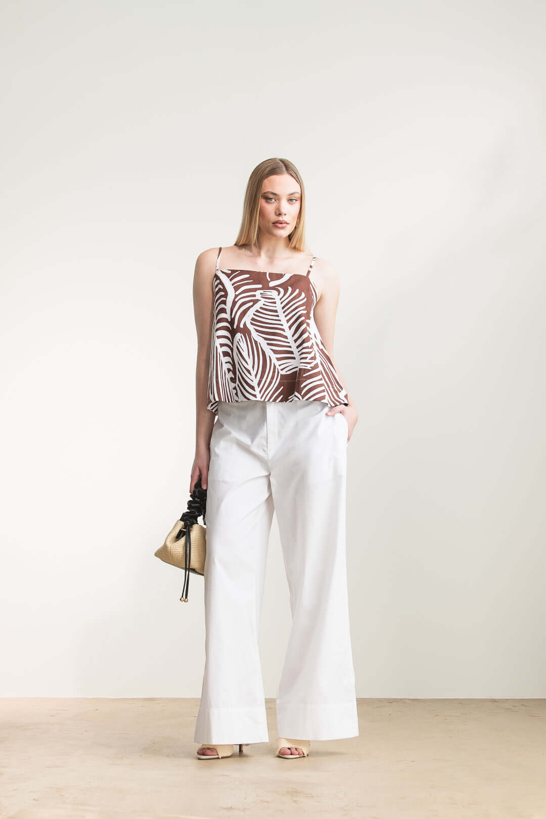 Model wearing Jesca Cami Top with adjustable straps and relaxed A-line cut, paired with white trousers.